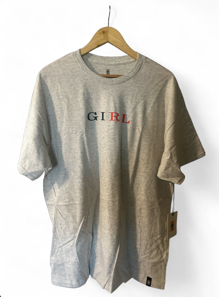 Ash gray short sleeve t-shirt with GIRL letterpress design hanging on wooden hanger